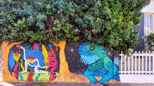 Giant space lizard mural under a tree