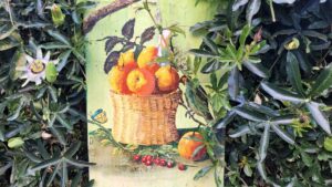 A mural of fruits in a basket surrounded by leaves
