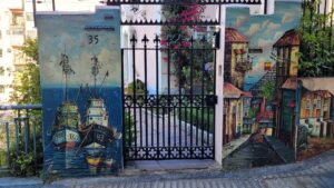 Outdoor paintings on each sides of a fence