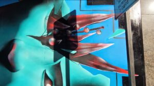 Shadow of a street sigh on a mural