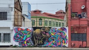 Colorful dinosaur mural on building wall