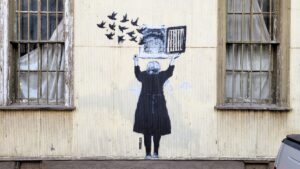 Mural of a woman opening a fake window