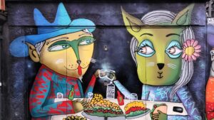 Colorful mural of animal characters having dinner