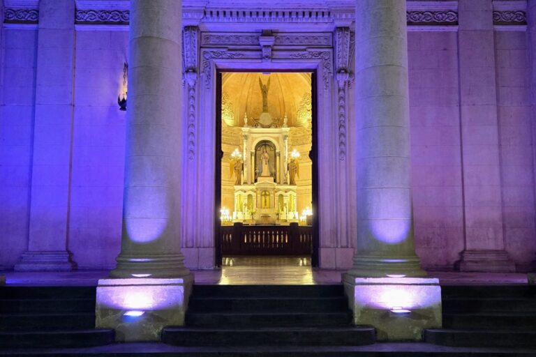 exterior Beaux-Arts purple walls frame a warmly lit church choir