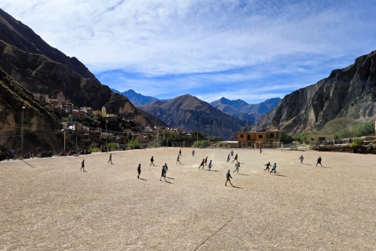 soccer field in the middle of mountains